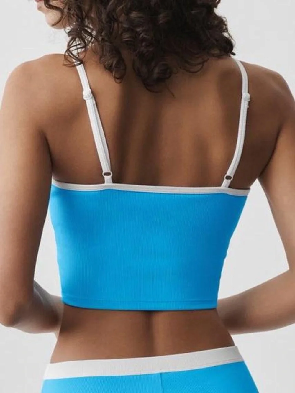 ALO Yoga Goddess Ribbed First Pick Bra Tank in Azure Blue with White Trim.